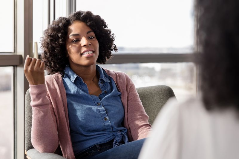 A dark-skinned woman at her counseling appointment