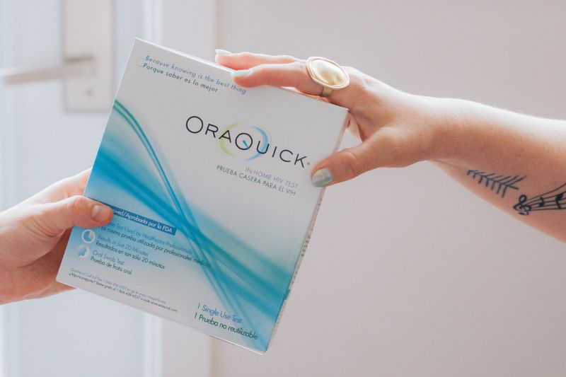 A person holding a OraQuick at home HIV test.