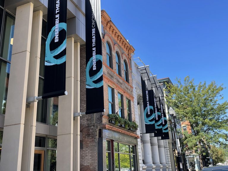 Exterior of Ensemble Theatre Cincinnati, a red brick building with large windows and a glass entrance, located in the Over-the-Rhine neighborhood of Cincinnati.